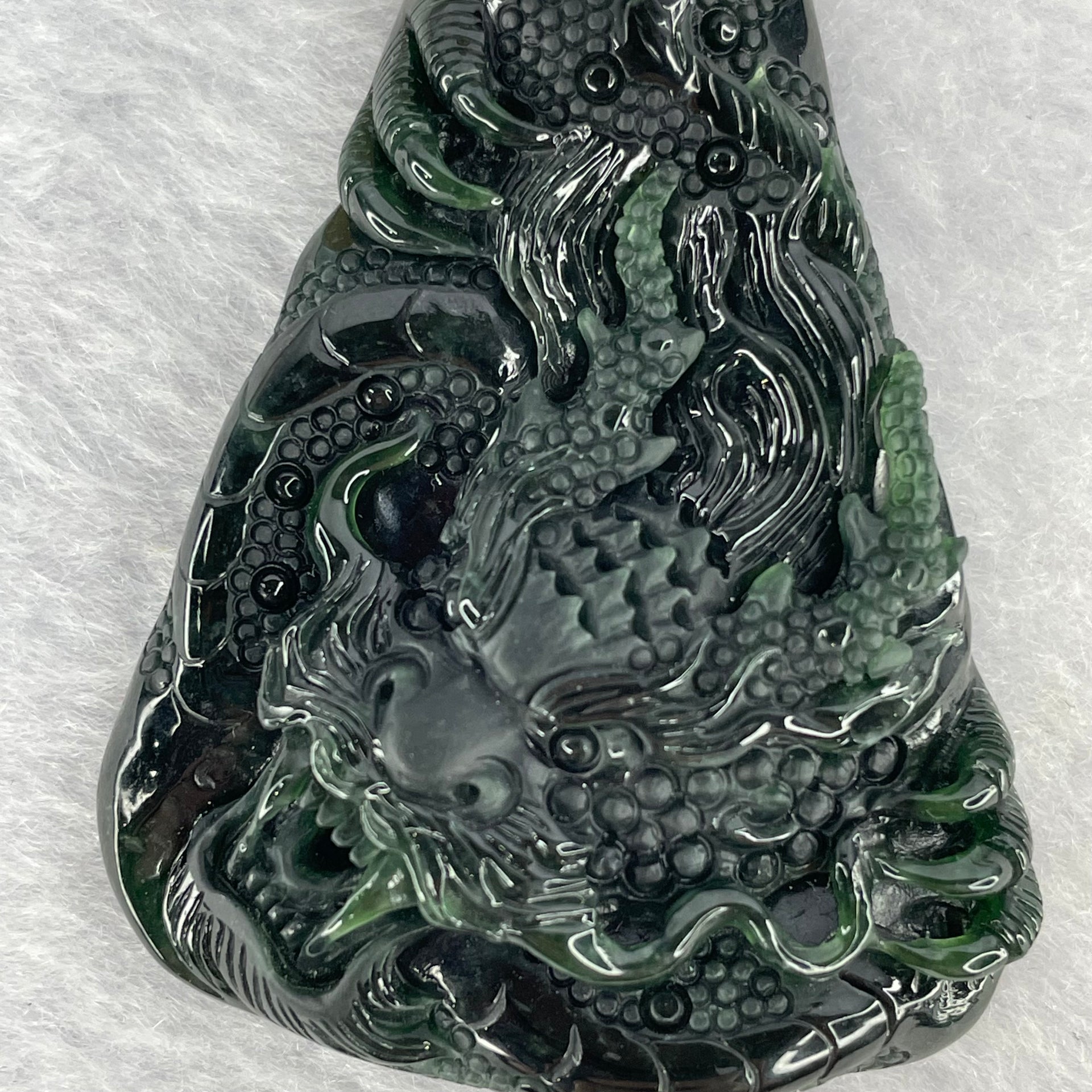 Rare High End Type A Fully Translucent Black Omphasite Jadeite Dragon (Shine Light is Dark Blueish Green) 罕见高端 A 货半透明黑色绿辉石翡翠龙  31.72g (Including String and 18K Hold Clasp) 53.75 by 40.40 by 9.65g with NGI Cert No. 82823872 - Huangs Jadeite and Jewelry Pte Ltd