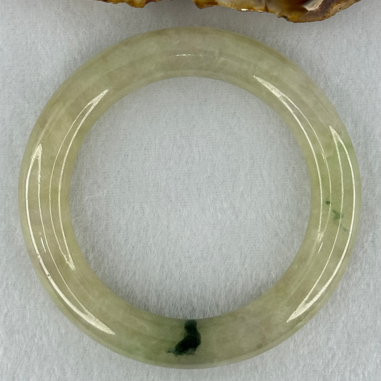 Type A Translucent Semi Icy Light Yellowish Green with Moss Green Patch Jadeite Bangle Internal Diameter 55.3mm 76.40g 12.3 by 11.6mm (Very Slight External Rough)