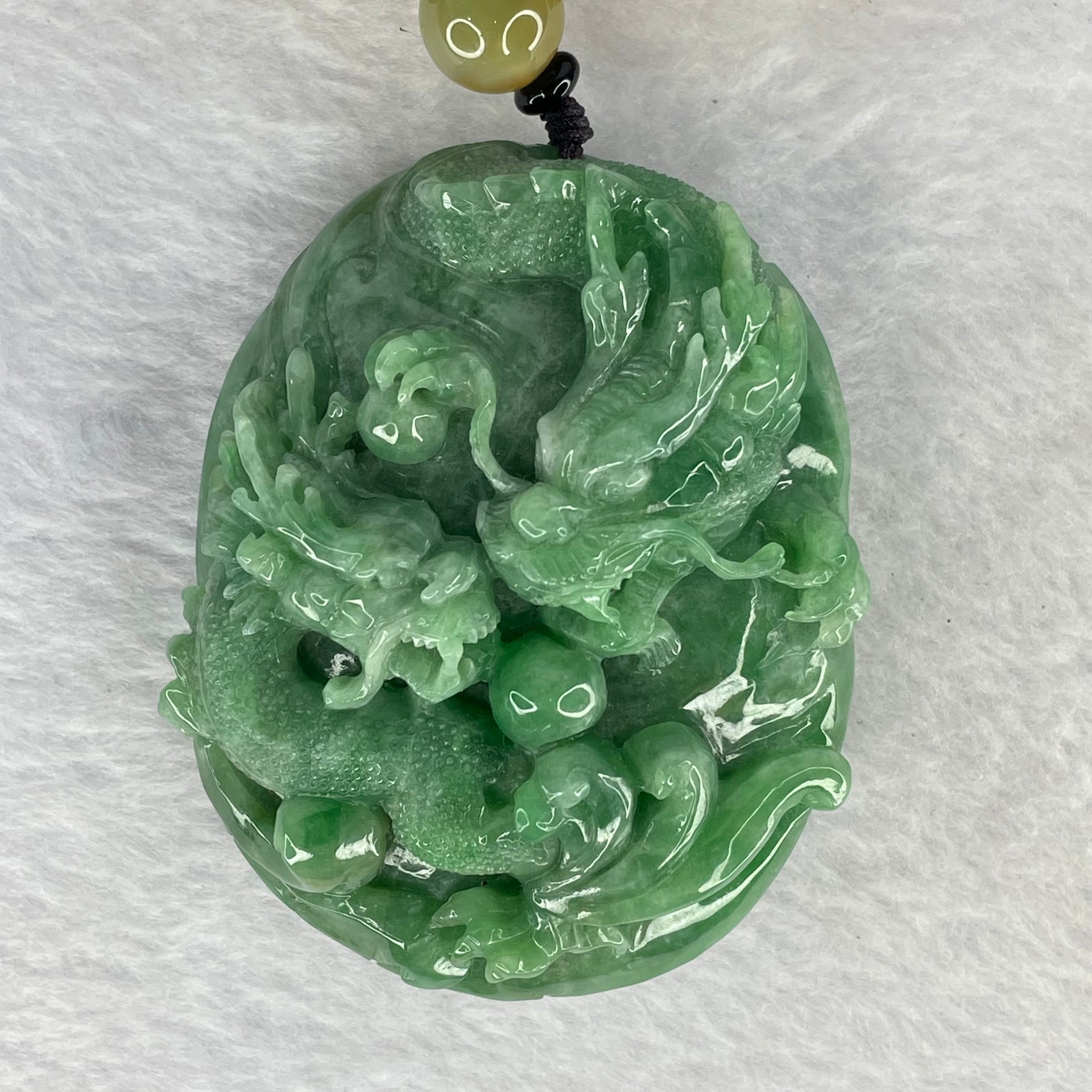 Rare Type A Good Translucent Full Green Jadeite Double Dragon and Coin with Hand Play String 罕见 A 货半透明全绿翡翠双龙手把件 181.89g 72.1 by 57.60 by 30.70mm with NGI Cert No. 82823875 - Huangs Jadeite and Jewelry Pte Ltd