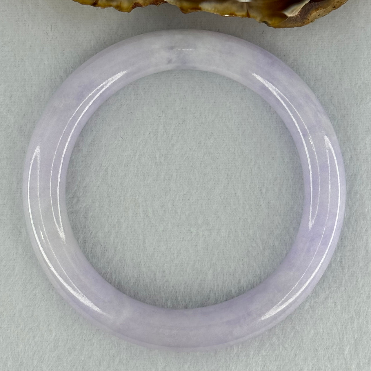 Type A Translucent Light Lavender Jadeite Bangle Internal Diameter 57.50mm 278.87cts 56.05g 10.1 by 10.5mm With NGI Cert No 32886053 (Slight External Line)