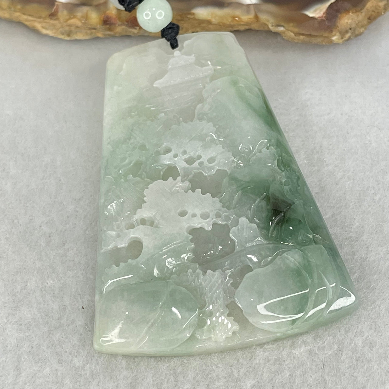 Type A Faint Lavender and Blueish Green Piao Hua Jadeite Shan Shui with Gui Ren Benefactor Pendant 29.99g 57.4 by 41.0 by 7.8mm