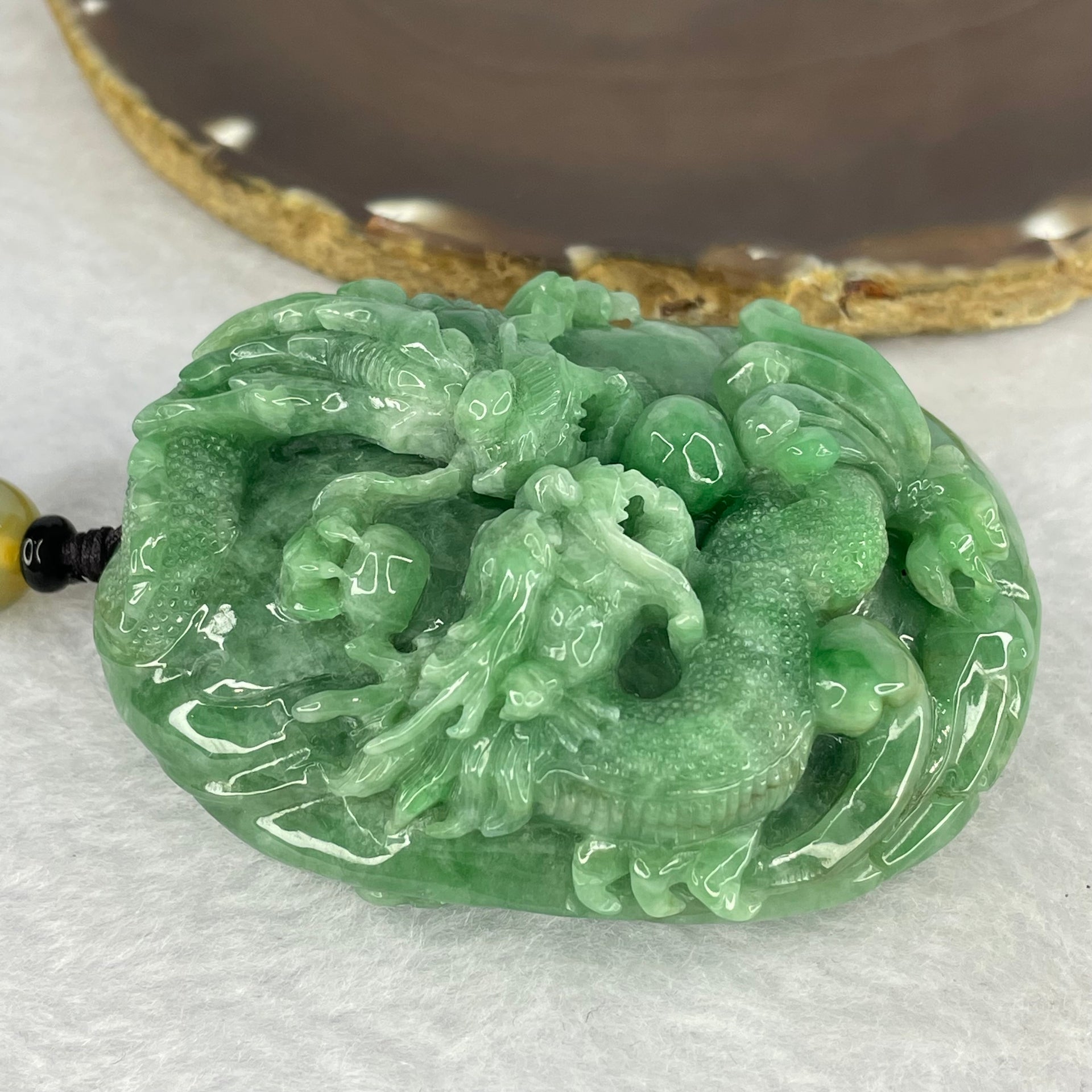 Rare Type A Good Translucent Full Green Jadeite Double Dragon and Coin with Hand Play String 罕见 A 货半透明全绿翡翠双龙手把件 181.89g 72.1 by 57.60 by 30.70mm with NGI Cert No. 82823875 - Huangs Jadeite and Jewelry Pte Ltd