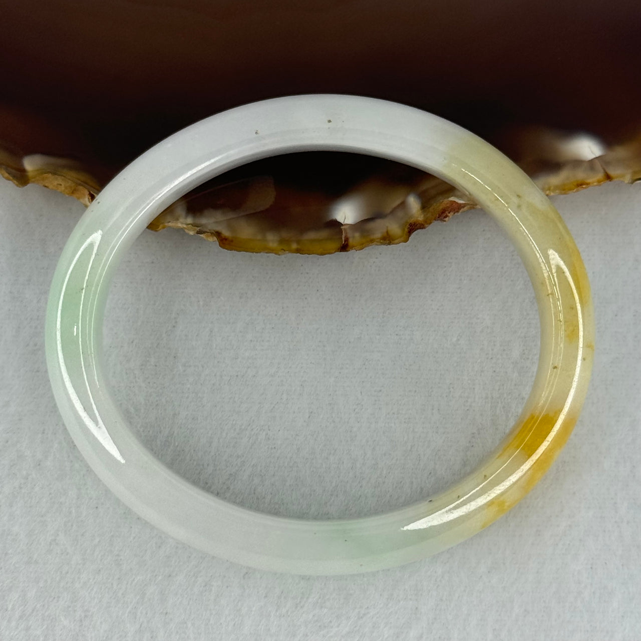 Type A Faint Lavender Green with Yellow Patches Jadeite Oval Bangle Internal Diameter 56.5mm  37.8696g 11.1 by 7.3mm (Very Slight Internal Line)