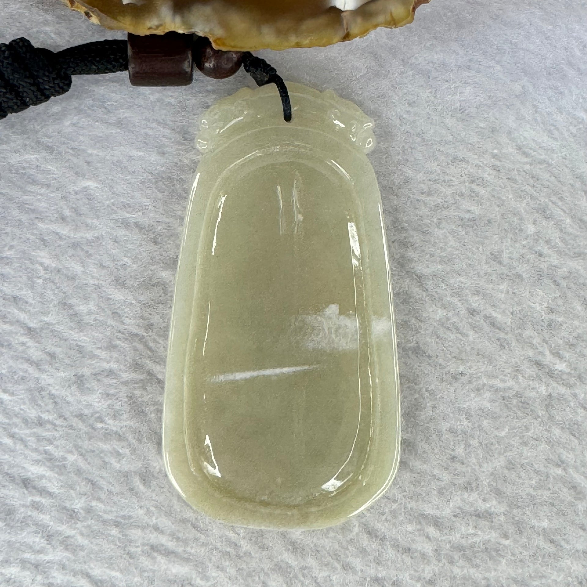 Type A Light Brownish Yellow Jadeite Guan Yin with Lotus Flower and Double Dragon Heads Pendent 24.38g 57.7 by 30.7 by 6.8 mm - Huangs Jadeite and Jewelry Pte Ltd