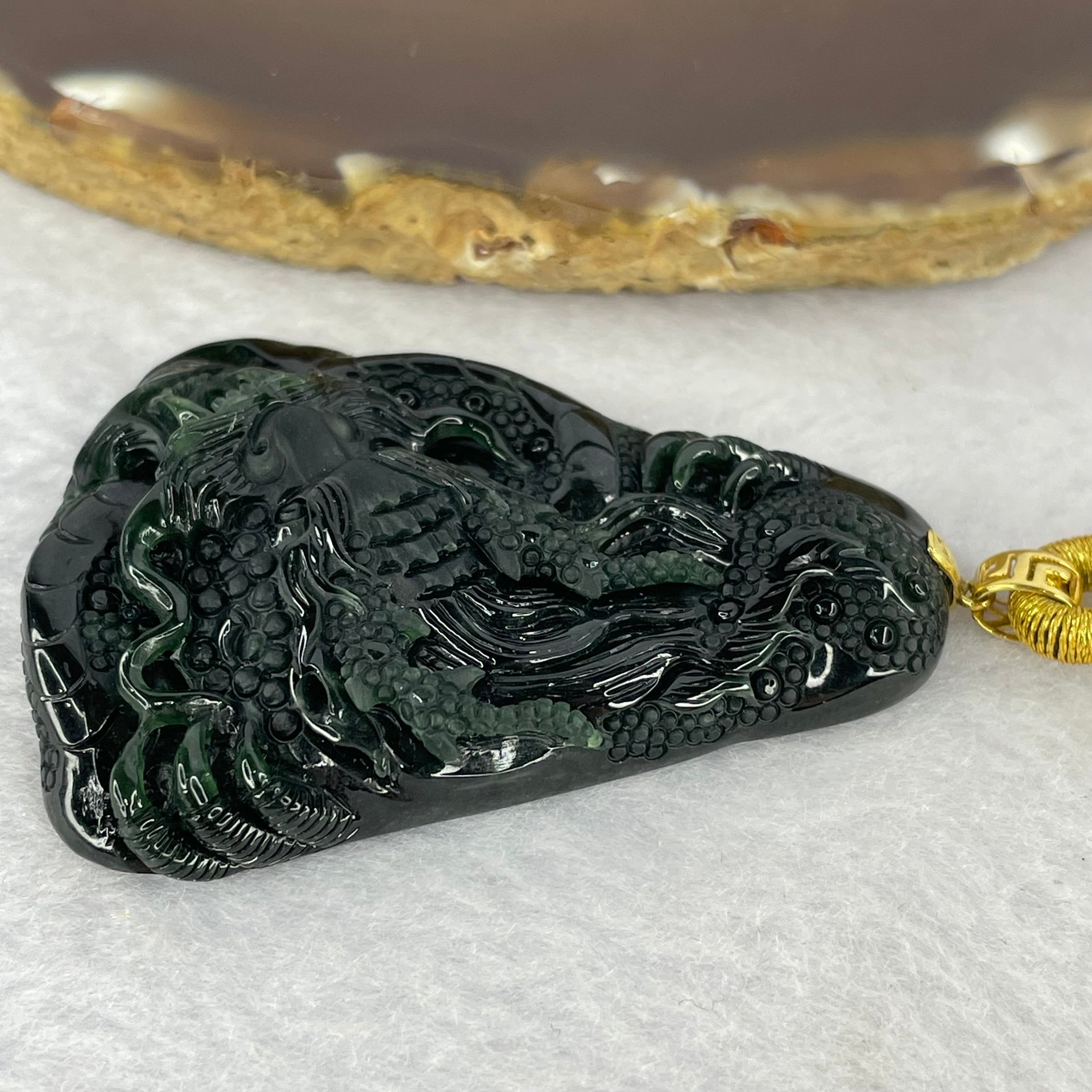 Rare High End Type A Fully Translucent Black Omphasite Jadeite Dragon (Shine Light is Dark Blueish Green) 罕见高端 A 货半透明黑色绿辉石翡翠龙  31.72g (Including String and 18K Hold Clasp) 53.75 by 40.40 by 9.65g with NGI Cert No. 82823872 - Huangs Jadeite and Jewelry Pte Ltd